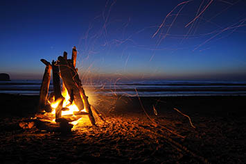 Sitting around a campfire on the beach
